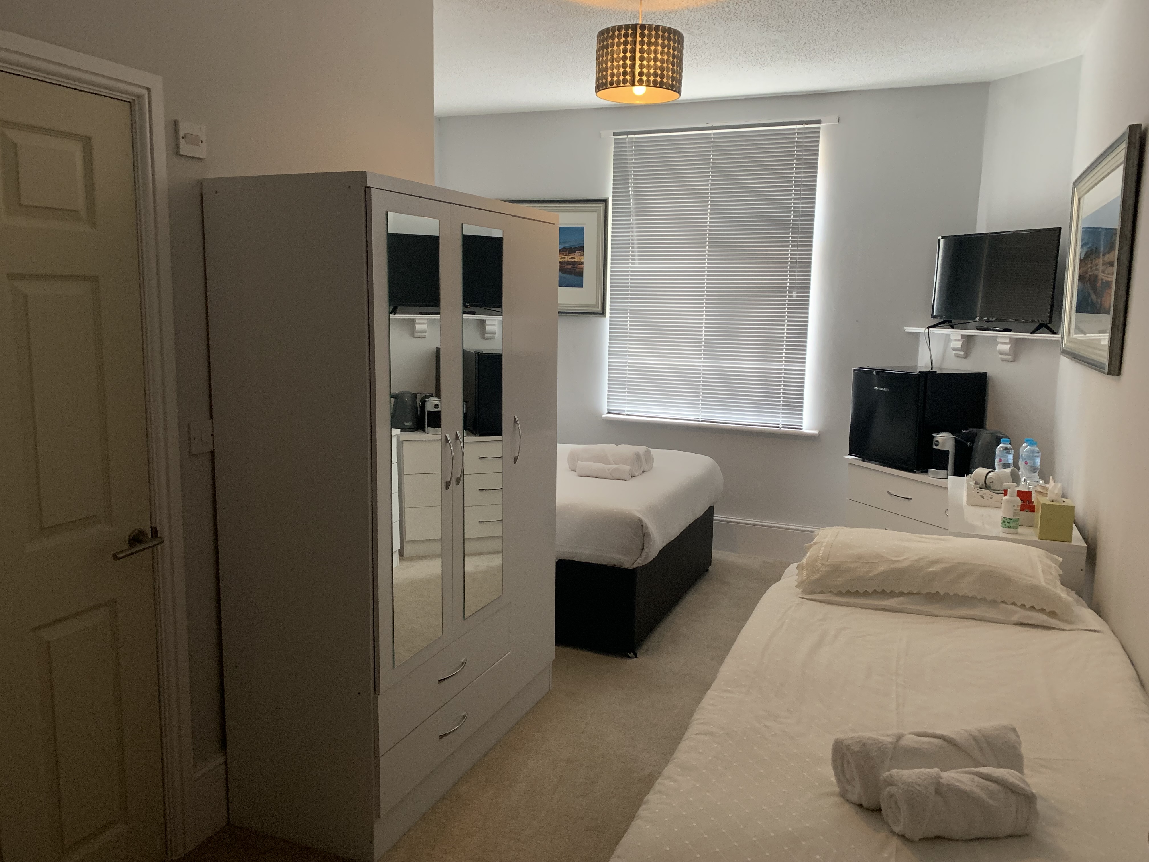 Guest room with modern decor, double bed and warm lighting